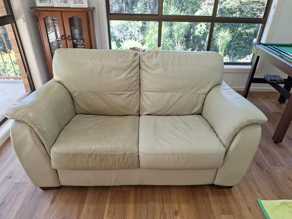A cream leather lounge after cleaning and conditioning