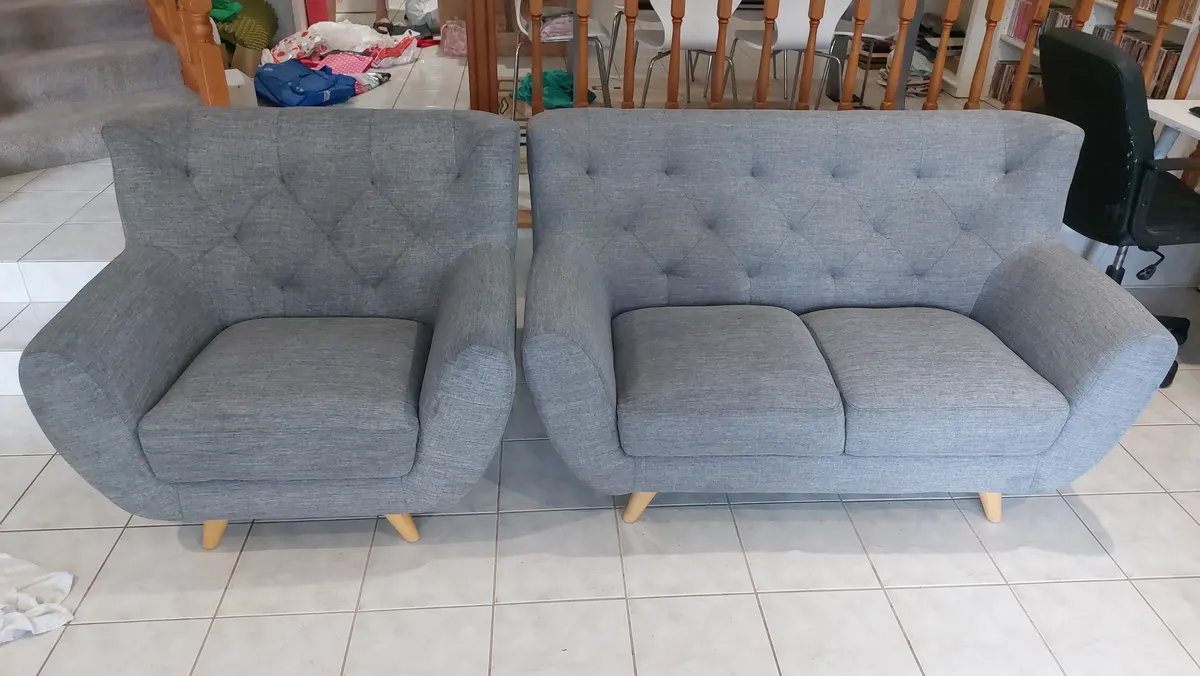 The same grey lounge suite after steam cleaning, evenly clean