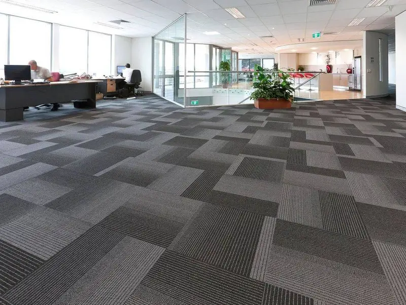 Commercial carpet tiles in an office being cleaned